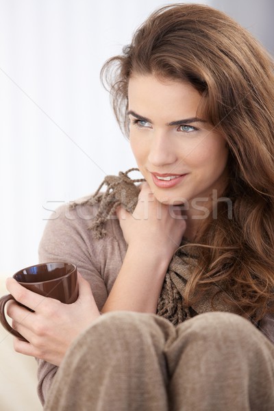 Young woman sitting with pulled up legs smiling Stock photo © nyul