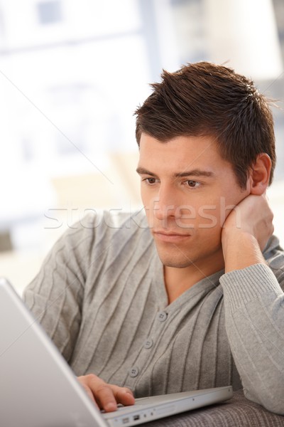 Goodlooking guy using laptop Stock photo © nyul
