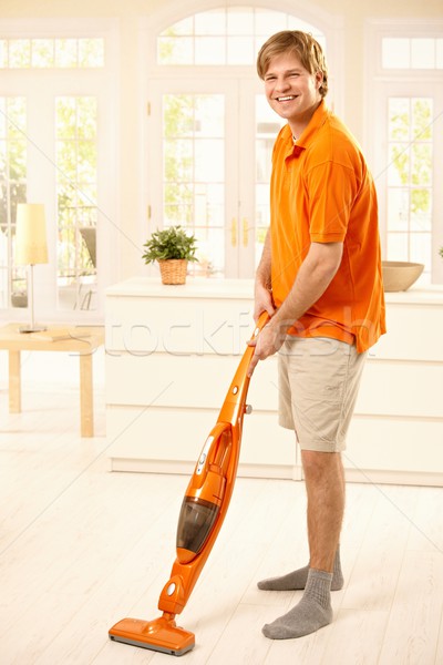 Stock photo: Happy guy with hoover