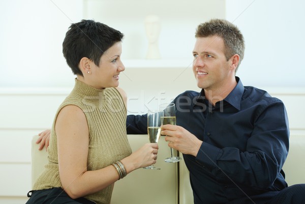 [[stock_photo]]: Couple · champagne · amour · verres · maison · canapé