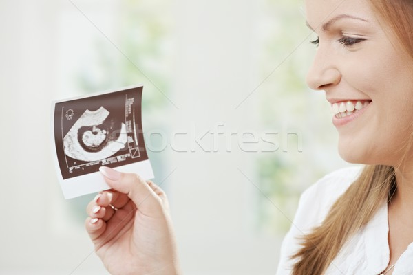 Pregnant woman holding sonogram Stock photo © nyul