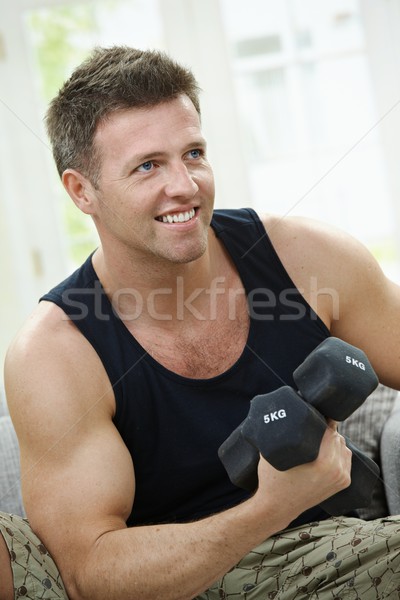 Home muskuläre Mann Sitzung Sofa Hand Stock foto © nyul