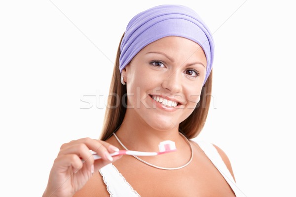 Vonzó fiatal nő fogmosás mosolyog fehér háttér Stock fotó © nyul