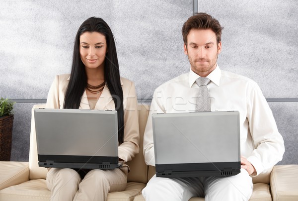 Young businesspeople sitting in office lobby Stock photo © nyul