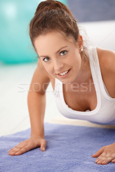 Stock photo: Portrait of attractive girl exercising on floor