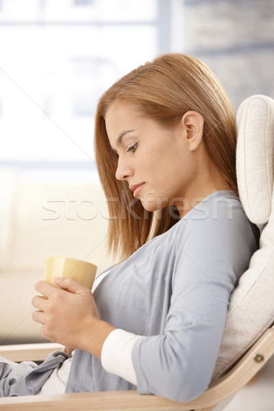 Young woman thinking, holding tea mug Stock photo © nyul