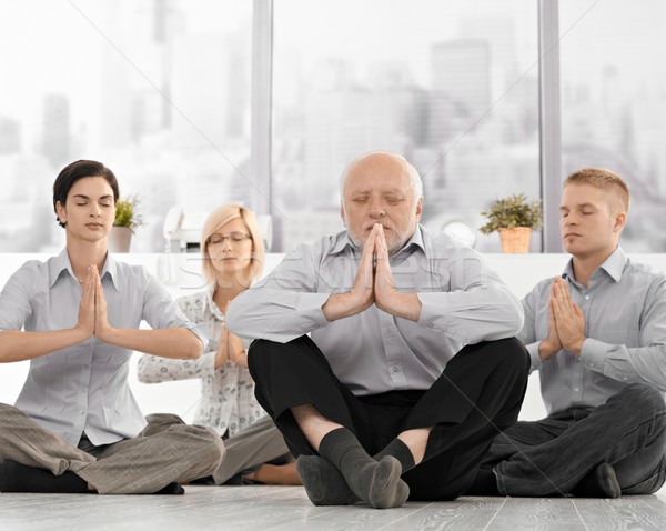 Businesspeople doing meditation in office Stock photo © nyul