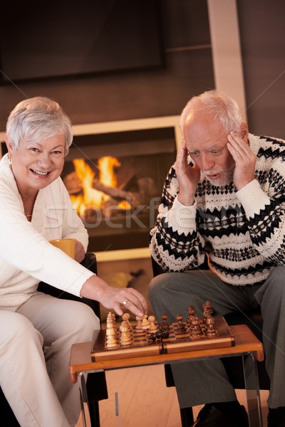 Couple playing chess in cosy living room Stock photo © nyul