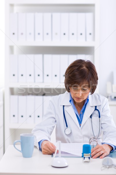 Female doctor working at office Stock photo © nyul