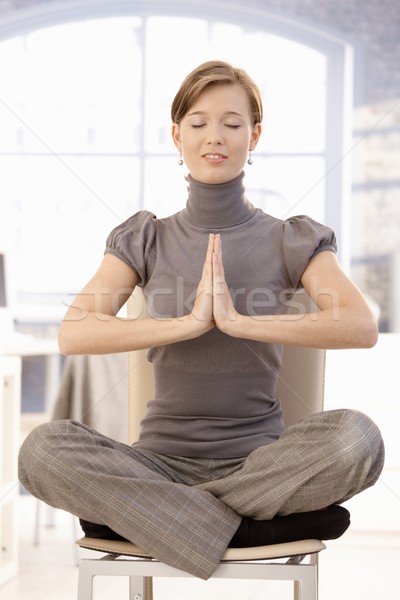 Young businesswoman practicing yoga Stock photo © nyul