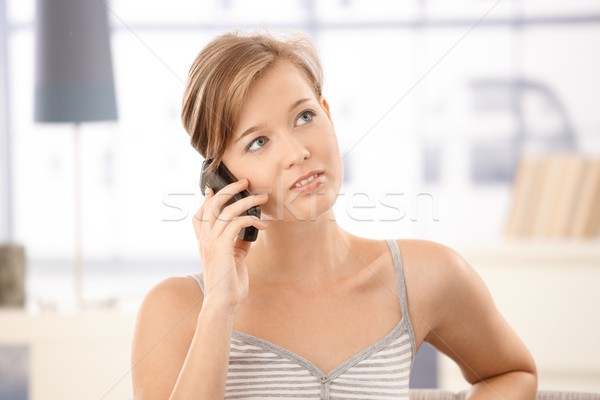 Young woman talking on mobile at home Stock photo © nyul