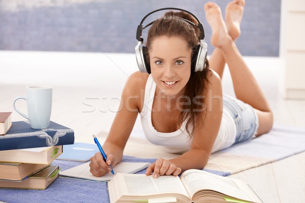 Pretty girl writing homework laying on floor Stock photo © nyul