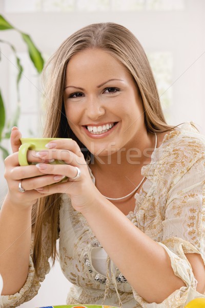 Stock photo: Happy woman holding tea cup