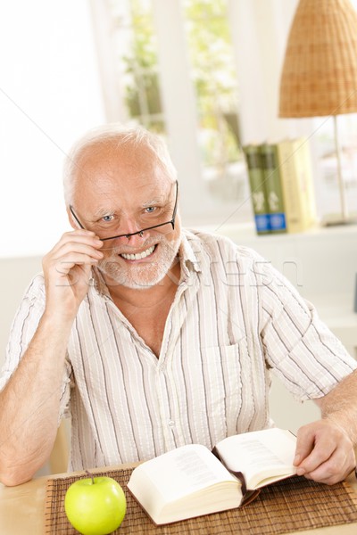 Portrait of laughing senior with book Stock photo © nyul