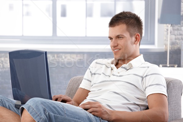 College student browsing internet at home smiling Stock photo © nyul