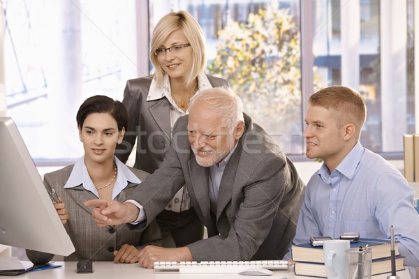 Senior executive discussing work with team Stock photo © nyul