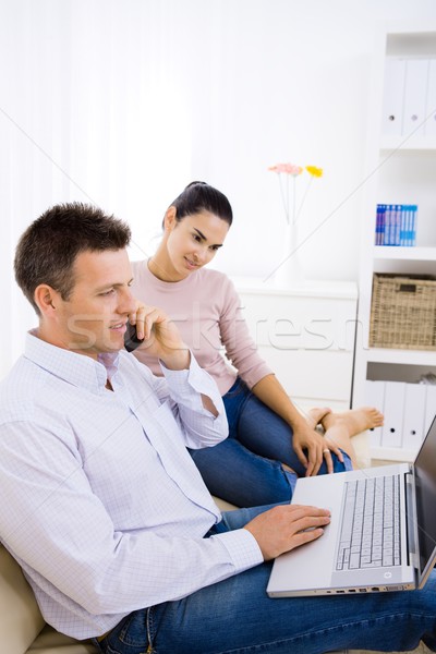 Casal usando laptop computador casa sessão Foto stock © nyul