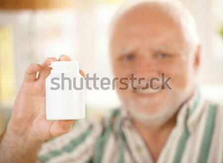 Gyógyszer fiola fókusz idős mosolyog férfi Stock fotó © nyul