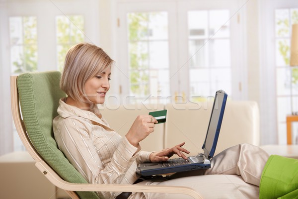 Woman using credit card on Internet.  Stock photo © nyul