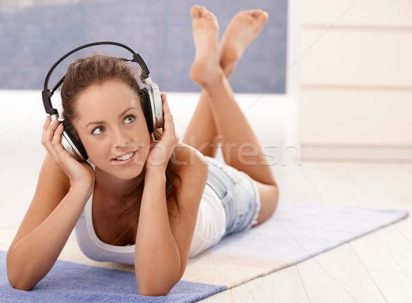 Attractive girl listening music laying on floor Stock photo © nyul