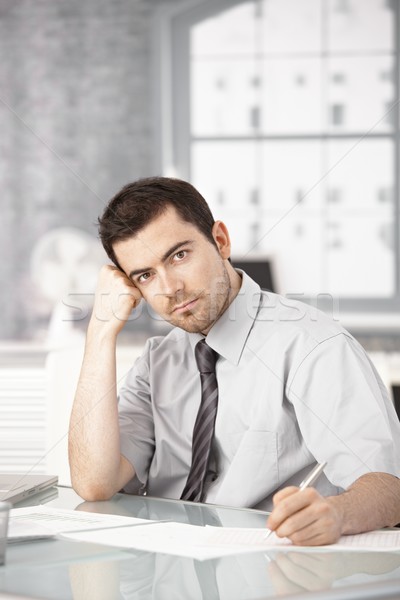 Young man working in office writing notes thinking Stock photo © nyul