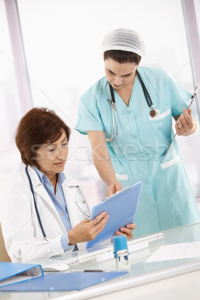 Nurse and doctor working in office Stock photo © nyul