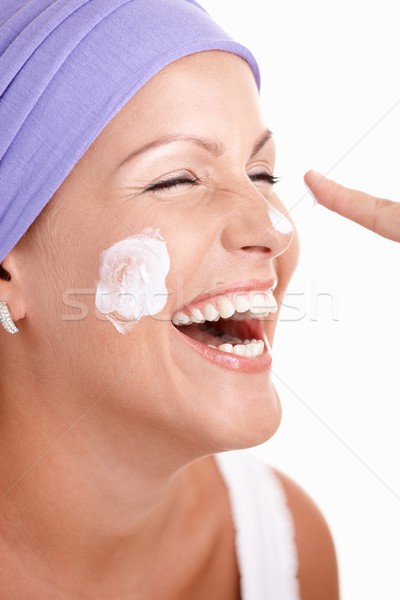 Stock photo: Portrait of attractive young girl applying cream