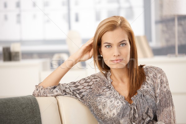 Attractive woman sitting on sofa Stock photo © nyul