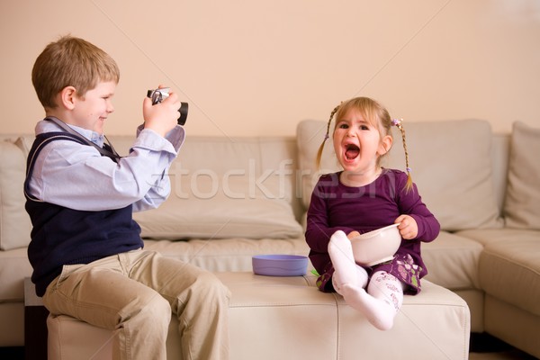 Stock photo: Boy taking picture of his sister