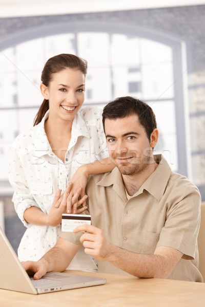 Happy couple enjoying online shopping smiling Stock photo © nyul