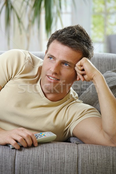 Uśmiechnięty człowiek sofa oglądanie telewizji przystojny mężczyzna nosić Zdjęcia stock © nyul