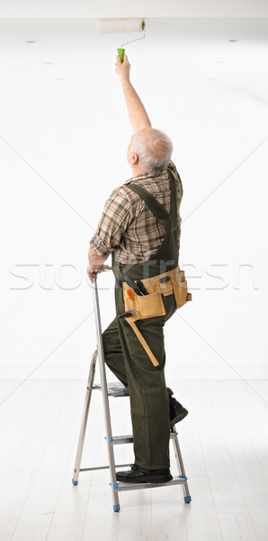 Senior handyman painting the ceiling Stock photo © nyul