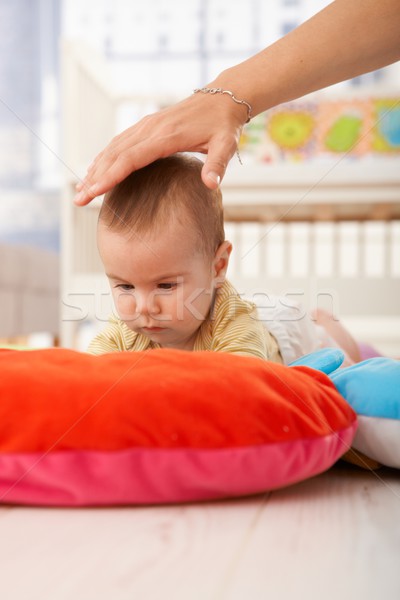 Baby on playmat concentrating Stock photo © nyul