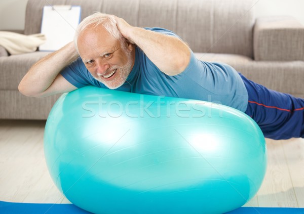 Active senior doing exercises on gym ball Stock photo © nyul