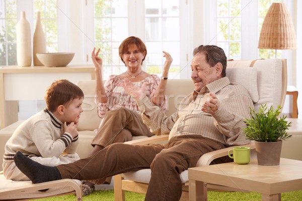 Nagyszülők otthon unoka ül nappali szórakozás Stock fotó © nyul