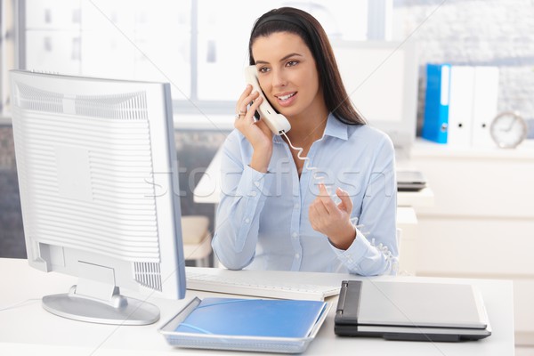 Stock photo: Woman at work on landline call�