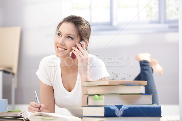 Attractive college girl on mobile smiling Stock photo © nyul