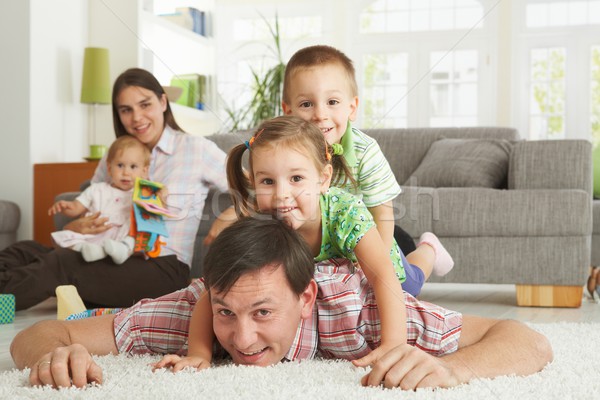 Gelukkig gezin poseren camera vloer woonkamer Stockfoto © nyul