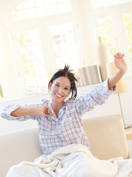 Happy attractive woman stretching in pyjama Stock photo © nyul