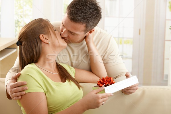 Stock photo: Kissing couple with present