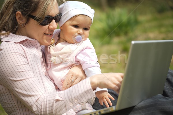 Mother uses a laptop Stock photo © nyul