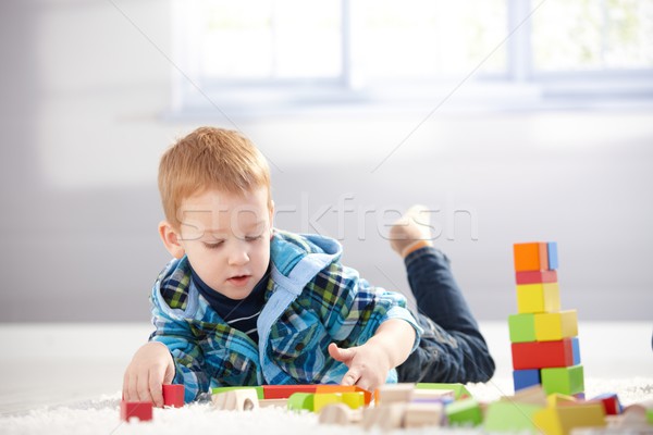 3 year old playing with cubes on floor Stock photo © nyul