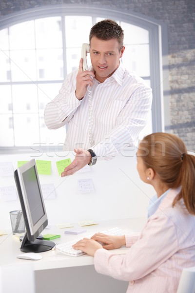 Stock photo: Young people working together in office�