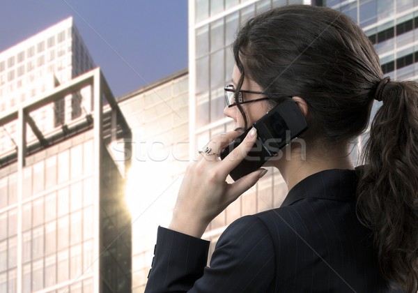 Young businesswoman talks on mobile Stock photo © nyul