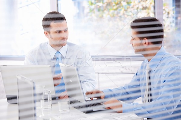 Young businessman working in bright office Stock photo © nyul