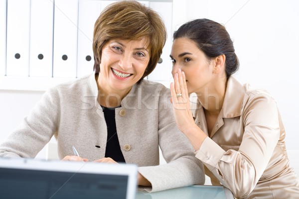 Whispering businesswomen Stock photo © nyul