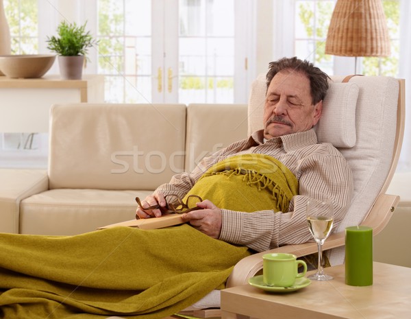 Senior man napping in armchair Stock photo © nyul