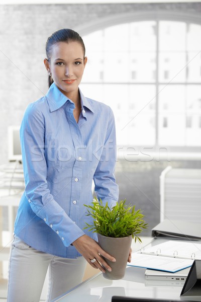 Young businesswoman holding potted plant Stock photo © nyul