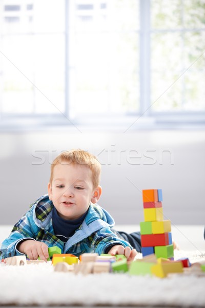 Ginger-haired toddler playing with cubes smiling Stock photo © nyul