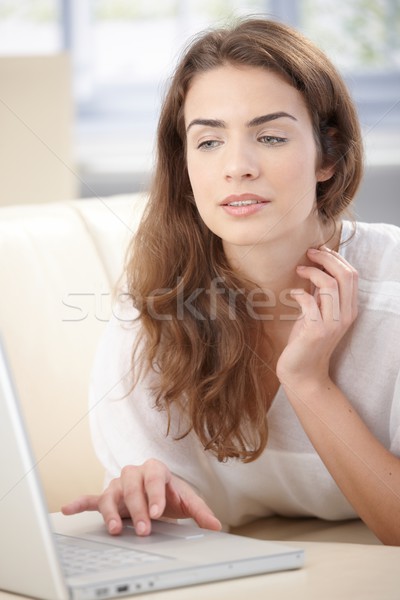 Young woman using laptop laying on sofa Stock photo © nyul